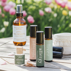 Collection of essential oil bottles on a wooden table with a garden background
