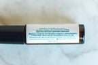 Essential oil blend rollerball with label on a white background