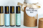Set of roller bottles labeled 'immunity', 'teething', 'stomach', 'relax' with a 'baby wellness kit' container.